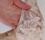 beige lace stretch floral fabric close up